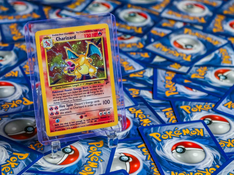 A high-value trading card surrounded by other cards on a desk