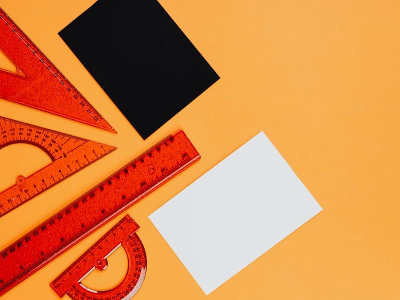 Measuring rulers and geometric tools arranged on a surface